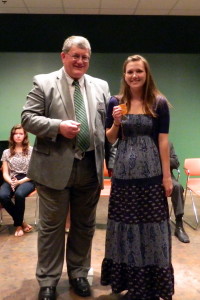 Greg Hoover, District Extension Director, presents Rachel Mumey with a Gold medal for her presentation, "Dipers and Wipers."