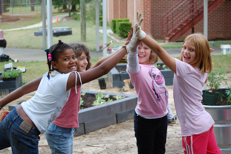 A group of school gardeners celebrating their gardening success!