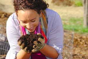 Woman Smiling a hand full of compost