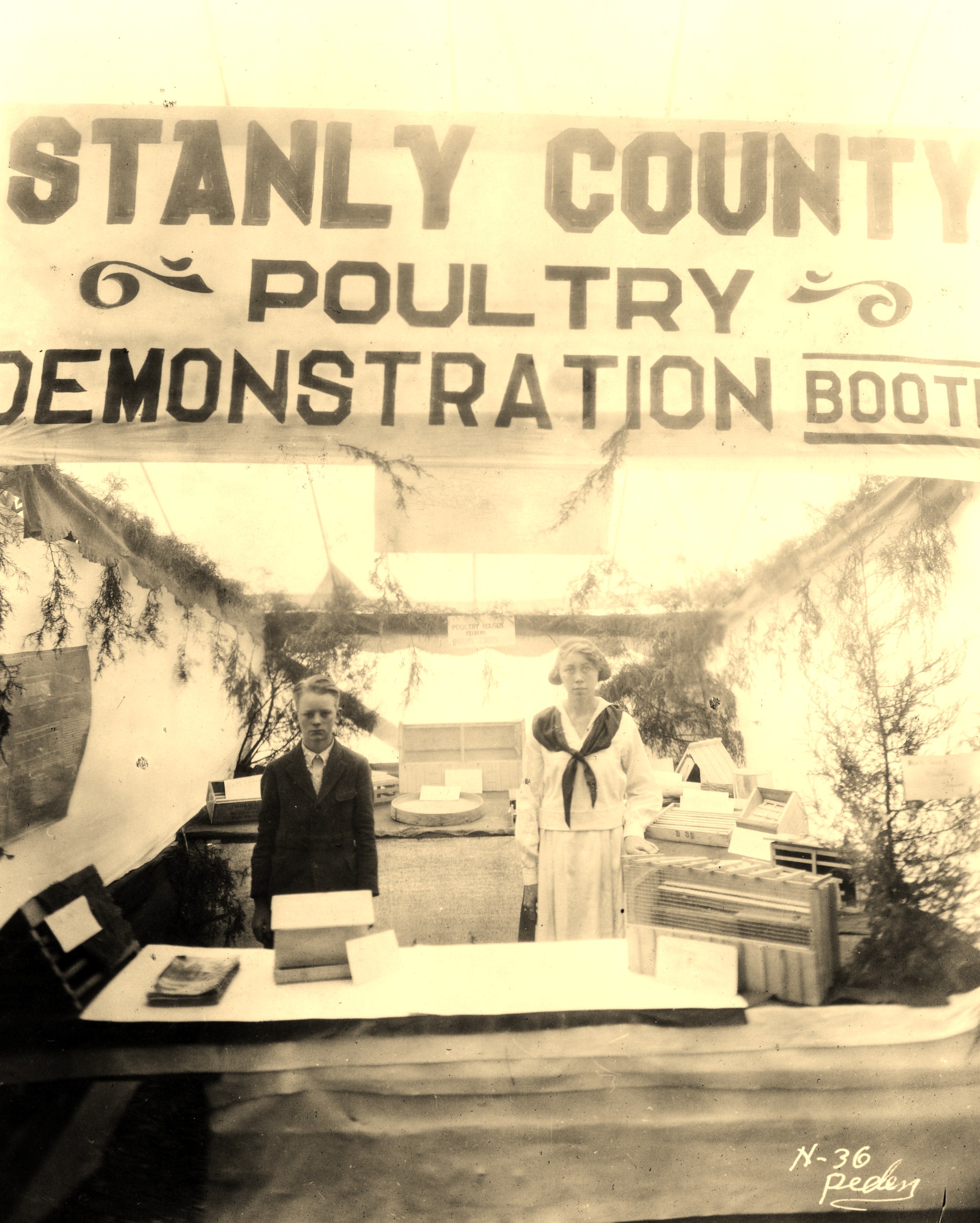 Agricultural club members staff a Stanly County Poultry Demonstration Booth in about 1922. Over time, club members would come to be known as 4-H'ers.