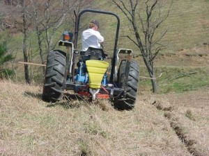 grower on tractor prepares field