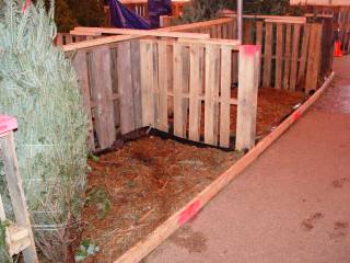 Water and mulch contained by pallet, 2x4,  and plastic structure 