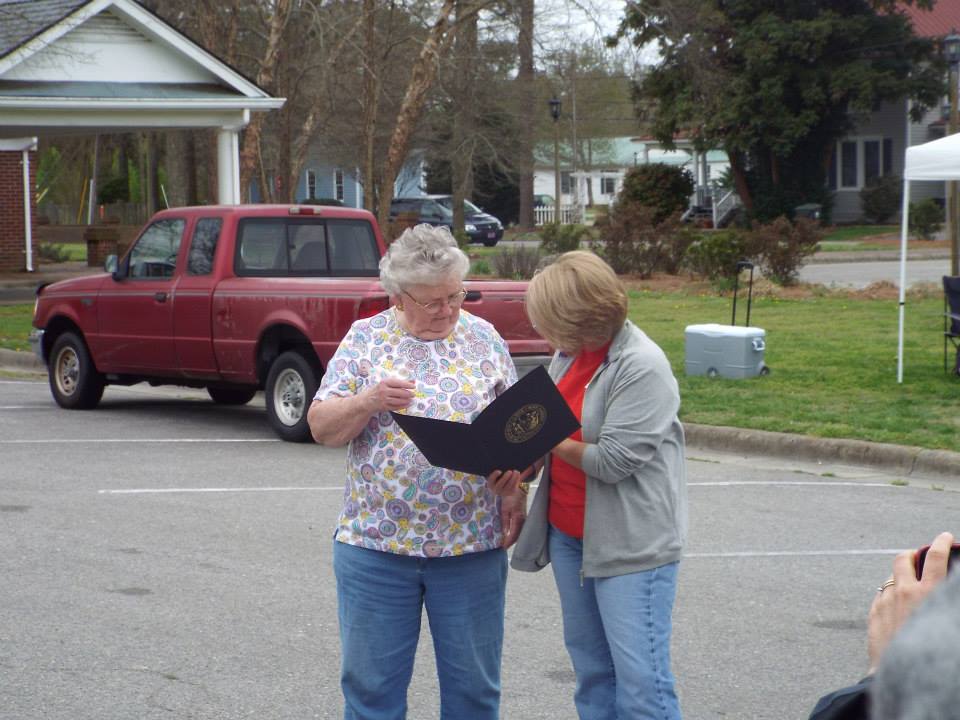Rebecca Castello, Hertford County Cooperative Extension Administrative Assistant presents Peggy Lowe with Murfreesboro Community Hunger Ministry a certificate and pin from NC Governor Pat McCroy as the Hertford County recipient of the Governor's Volunteer Award for 2014.