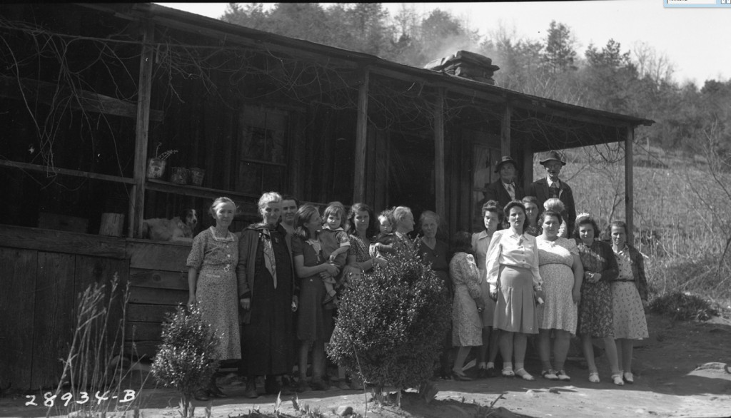 A group of ladies gathered for a canning demonstration at Roxie McClure's home. Pictured: Lou Chambers, Martha Anthony, Lydia Crisp, Maudie Earley with daughter, Ida Kirkland with daughter, Grandmother Woody, Mary Crisp, Tina Kirkland, Kate Shook, Mossie Kirkland, Hattie Kirkland with son, Hazel McClure, Edna Anthony, Allie Anthony. Back row: John Chambers (Along the River: People and Places ~ Duane Oliver)