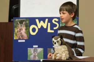 Quinn O'Keefe, Shamrock 4-H Club member, teaches the audience about the unique trails of owls.