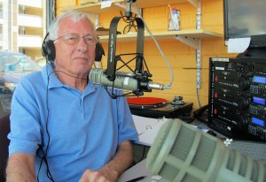 Harold Johnson, show host, behind the mic at WCOM 103.7 FM [Photo: Lise Jenkins, EMGV in Durham county]