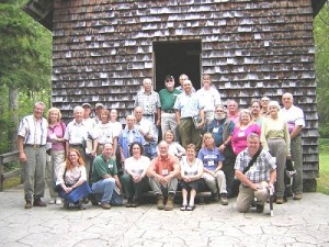 Attendees of the Woodland Stewards Series gather for a picture on the steps of the Biltmore Forest School at the Cradle of Forestry