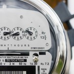 Close-up of an electric meter with lock in background.