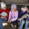 Some young visitors enjoy hanging out with the goat kids at Celebrity Dairy. Photo by Debbie Roos.