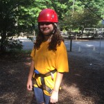 Road Runner 4-Her Kacey Field preparing to climb the rock wall.