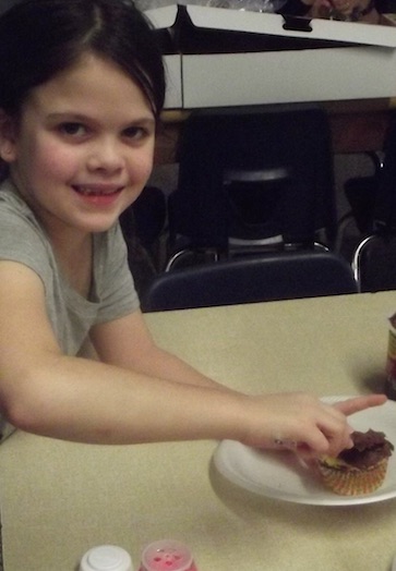 child eating a cupcake