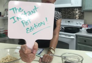 Extension Director holding sign that says "The Instant Pot Edition"