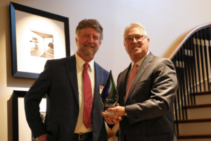 Tom Ranney with Chancellor Woodson being presented with Innovator of the Year award