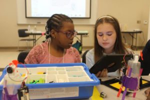 Two girls working on coding project