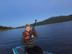 Ladan paddleboarding at night.