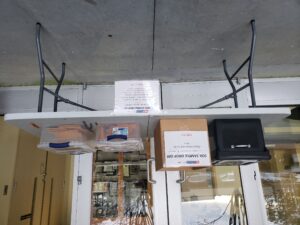 Plastic table with four boxes to indicate where soil sample kits can be picked up and returned