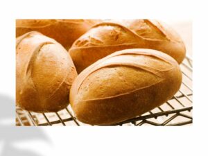loaves of fresh baked bread on rack