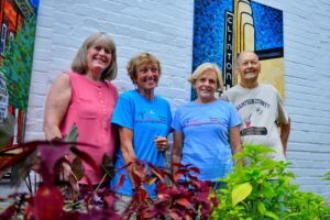 four volunteers pose for photo in downtown Clinton, NC