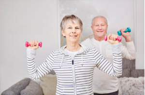 Senior couple lifting weights