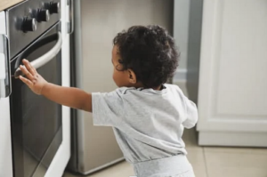 baby touching stove