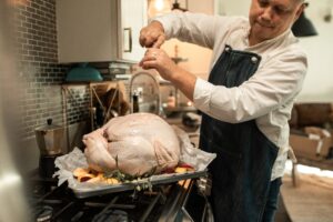 Man Preparing Turkey For Thanksgiving