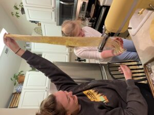 picture of child and adult making pasta