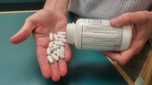 pouring pills out of bottle into open palm
