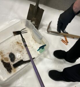 plastic tub with rusty garden hoe in vinegar