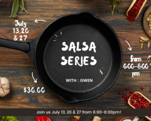 Cast iron skillet on wood table with spices around it.