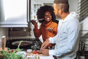 man and woman in kitchen cooking