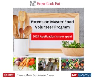 Vegetables, Cooking Class Students, food display of fish and vegetables. The message Extension Master Food Volunteer Program is on a dry erase board. Wooden spoons in a container