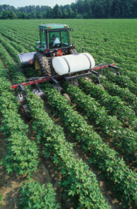 A farmer uses a tractor to tend to his field.