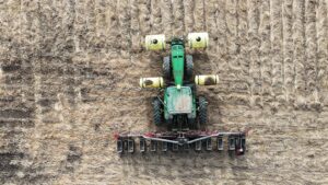 tractor in field with planter attached