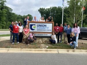 Group of participants in front of Simpson Event Center sign