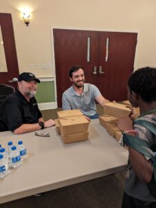 Chef John LaTour, Healthy Families-Healthy Futures and Avery Ashley, Family and Consumer Science Extension Agent pass out meals at the Care Fair