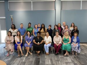 Group of men and women posing for a group photo.