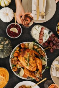 Thanksgiving turkey, cooked, on a table with side dishes.