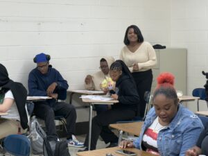 Teacher and students learning in a class room.