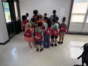 Lincoln Elementary students wearing their EFNEP draw-string bags after completing Eat Smart, Move More & Camp Cook Play