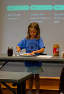 4-H youth presenting how to make a peanut butter and jelly sandwich at county activity day 2025 - provided by Megan Sweeney
