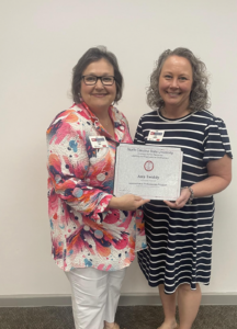 Picture of Sandy Hall presenting certificate to Amy Twiddy