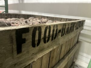 box with black text reading Food Bank CENC on the side